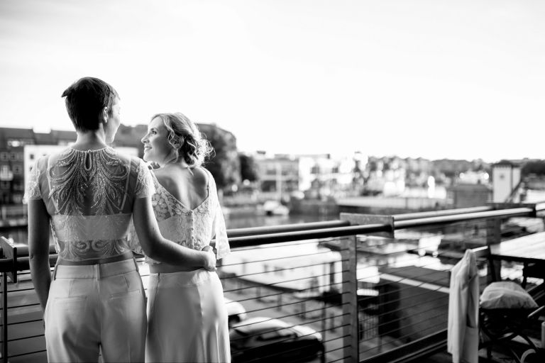 Brides on the balcony at the Mud Dock bristol