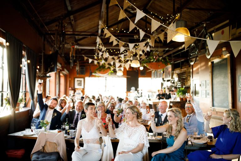 Raising a glass for a toast at the Mud Dock wedding Bristol