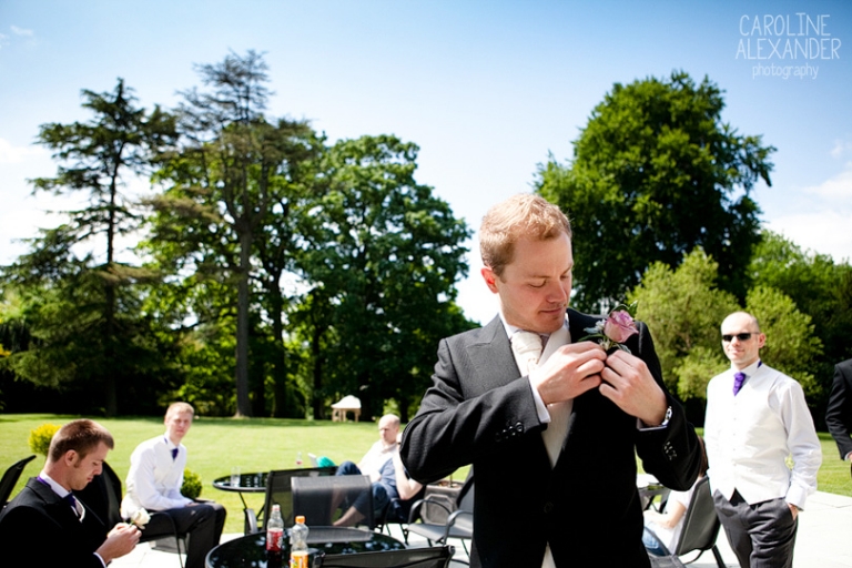 groom putting on buttonhole