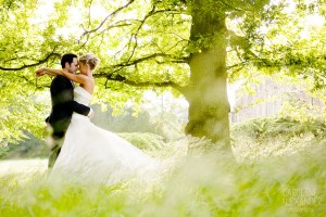 wedding couple in the long grass at Aynhoe Park