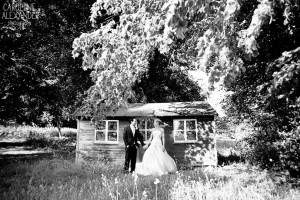 bride and groom at little hut at Aynhoe Park