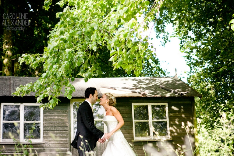 bride and groom at little house at Aynhoe Park