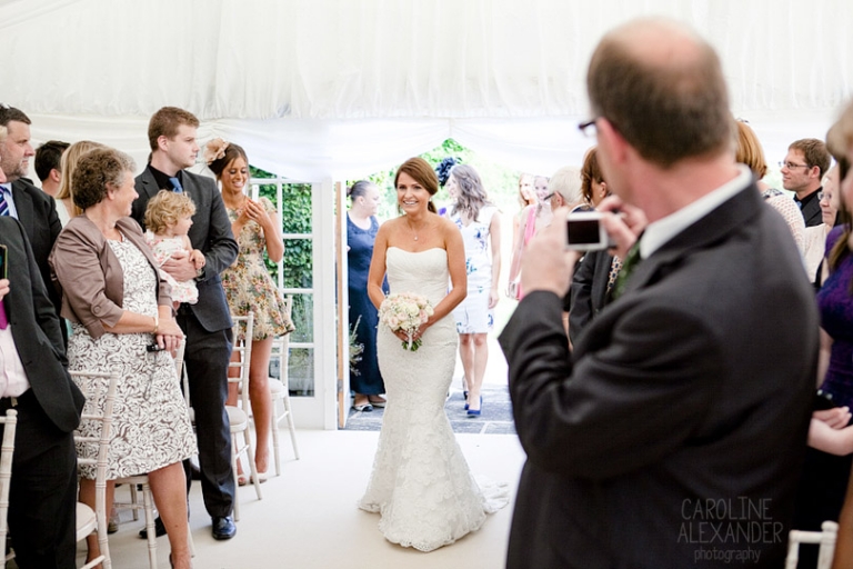 bride walks up aisle alone at Barton House