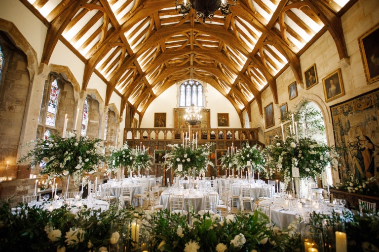 Berkeley Castle Wedding - the great hall decorated with extravagant flowers