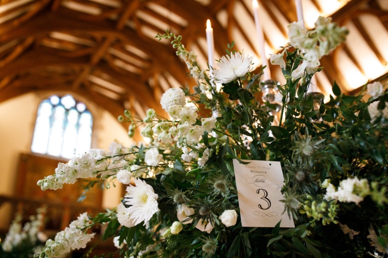 Berkeley Castle Wedding - flowers and table number with castle roof in background