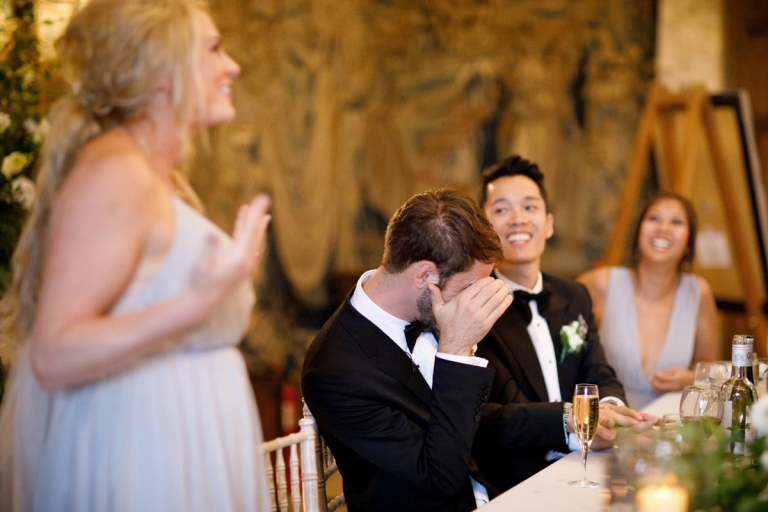 Berkeley Castle Wedding - groom hides his face with embarrassment at his sisters wedding speech