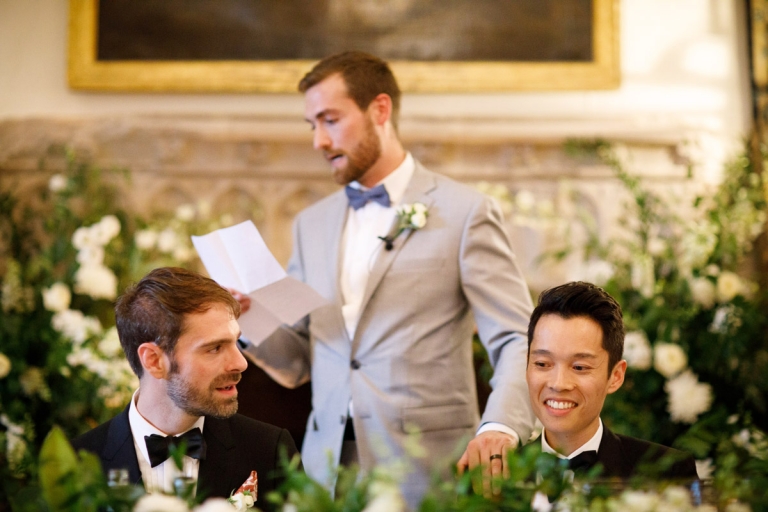 Berkeley Castle Wedding - friend gives speech and rests a hand on one of the grooms shoulders