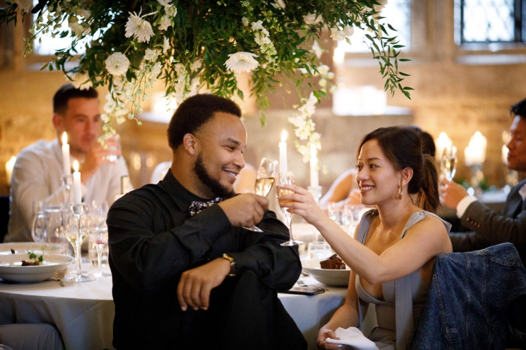 Berkeley Castle Wedding - couple clink glasses during wedding toasts