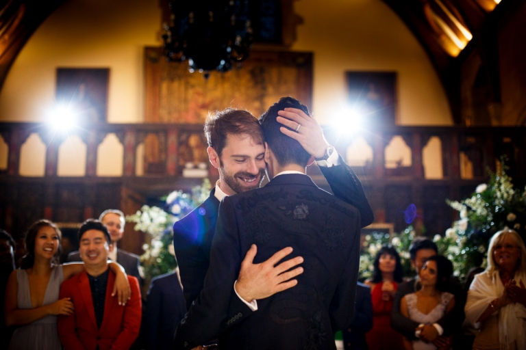 Berkeley Castle Wedding - first dance of two grooms, lit with two big lights behind which give lens flare