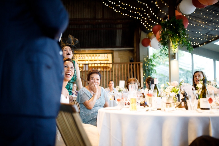 brides mum laughs and looks embarrassed during speech at stone barn