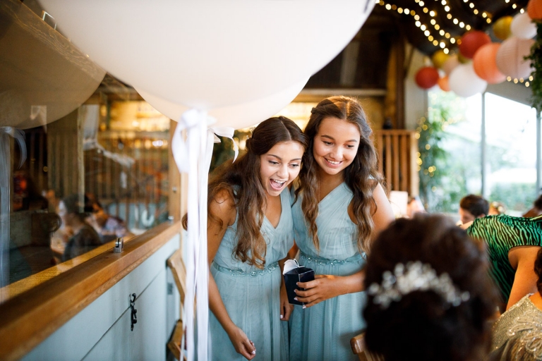 bridesmaids in light blue bridesmaids dresses show excitement to bride at wedding at cripps stone barn