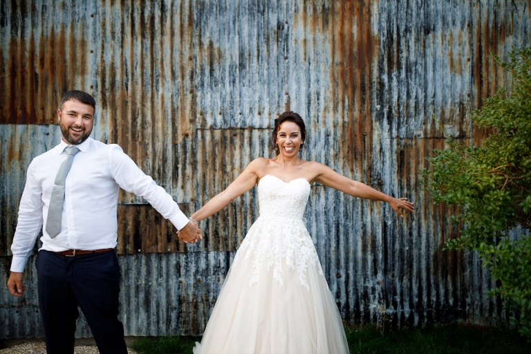 Couple grinning outside their wedding venue cripps stone barn