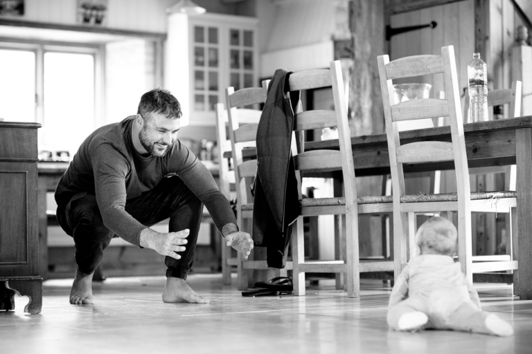 Groom plays with baby at Cats Abbey