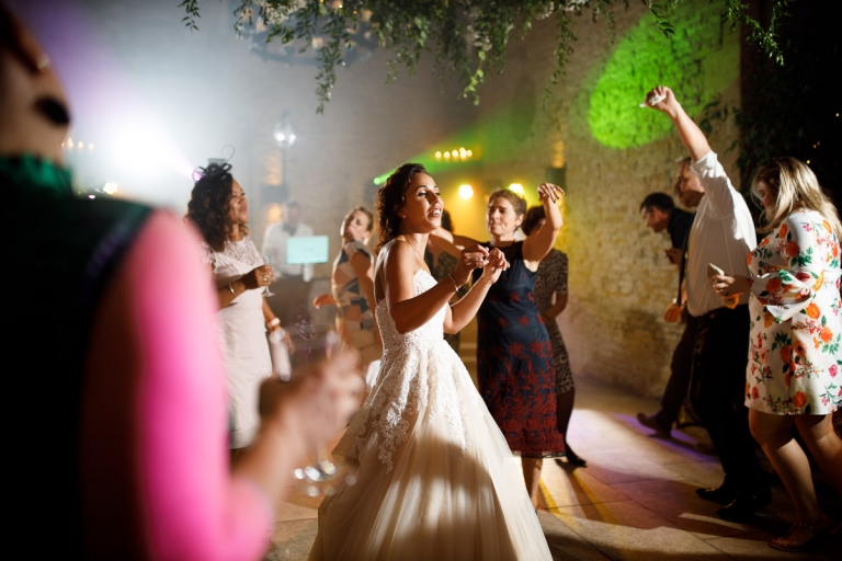 Bride dancing with colour lights at cripps stone barn