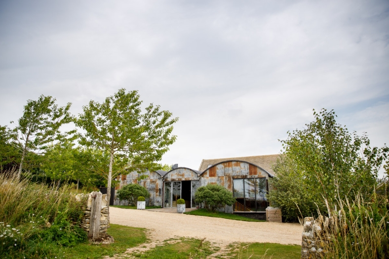 Cripps Stone Barn wedding photos. Corrugated iron barn surrounded by trees and the countryside.  