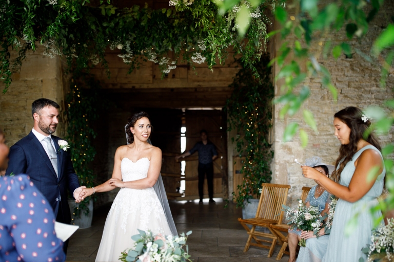 Bridesmaid does a reading during ceremony at Cripps Stone Barn