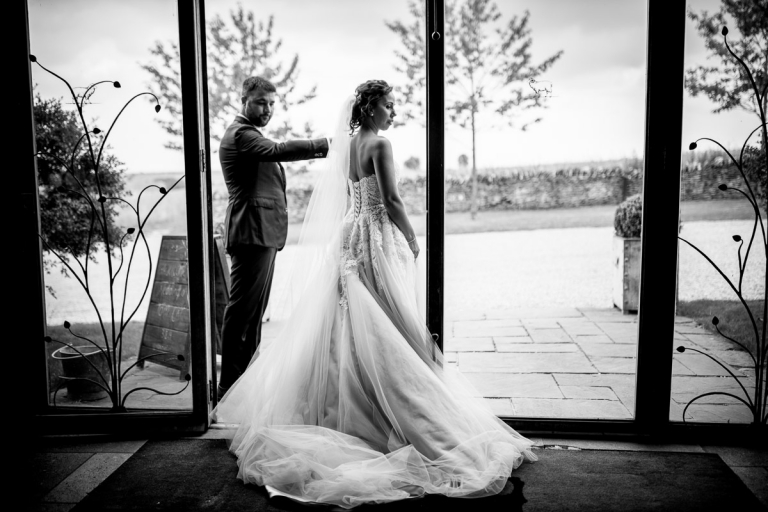 bride and groom exit wedding ceremony at stone barn