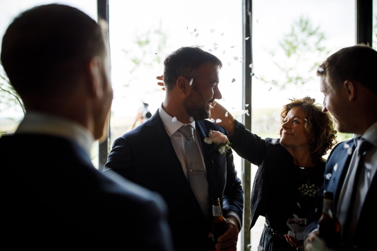 Grooms Mum throws confetti over her Son at Cripps Barn