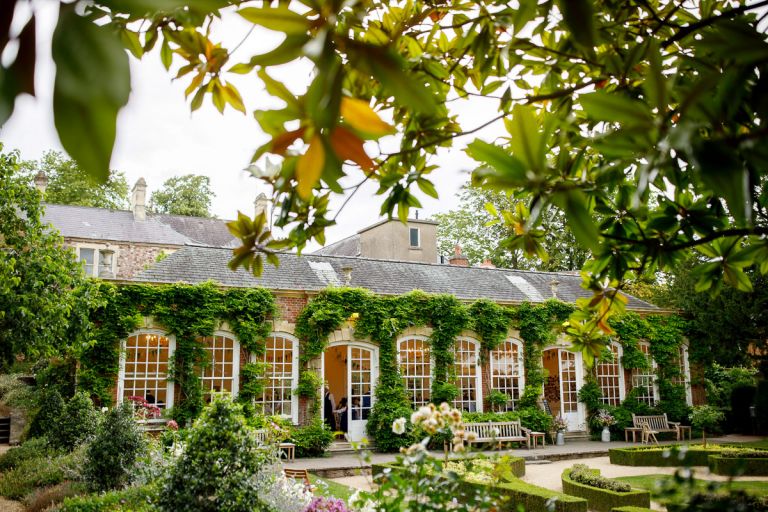 The orangery at goldney hall, covered in greenery.