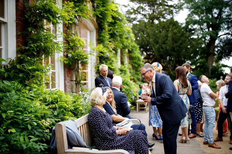 Guests laugh together outside the orangery 