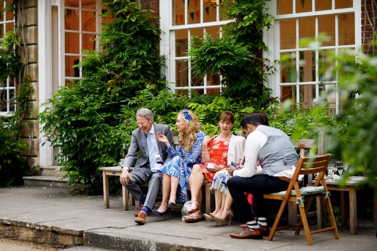 Lady makes man laugh at wedding outside in bristol