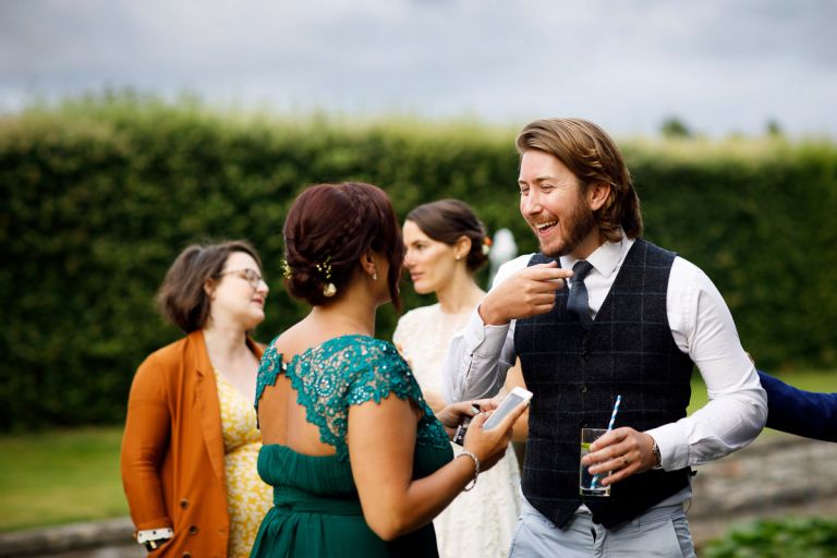 Guest at wedding in waistcoat in bristol laughing