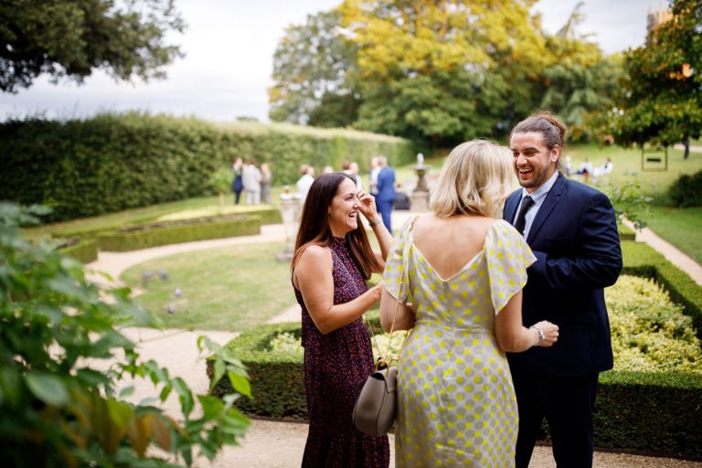 Guests laughing as they chat during evening reception at goldney hall