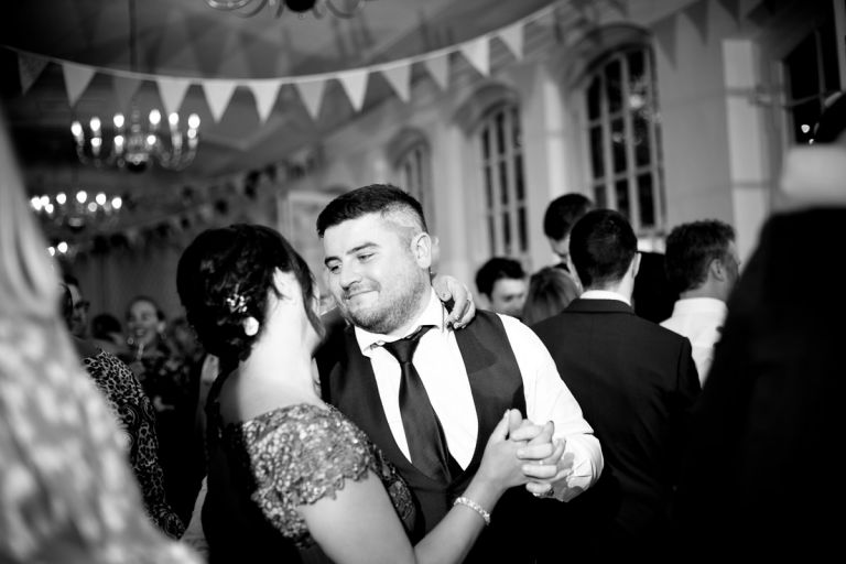 a couple dance together at a wedding in the orangery at goldney hall