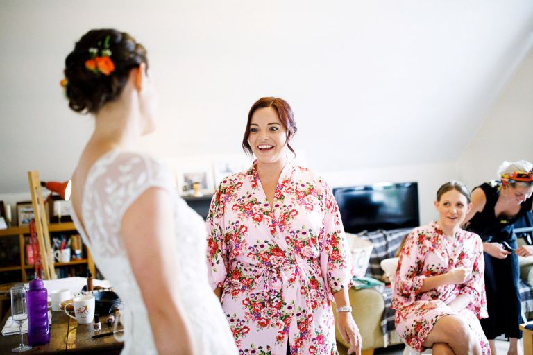 bridemaids see bride in dress for the first time 
