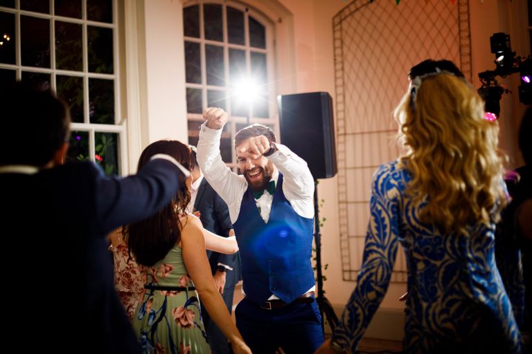 Usher dances with lens flare at goldney hall in the orangery after the outside wedding