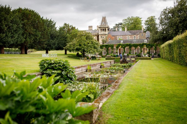Goldney Hall wedding, view from the gardens looking back towards the orangery with pond in foreground