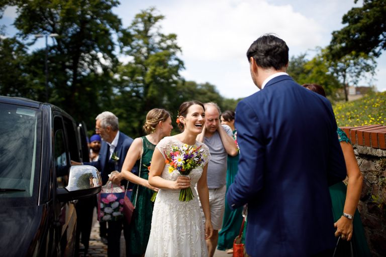 bristol bride arrives by taxi to goldney hall in clifton
