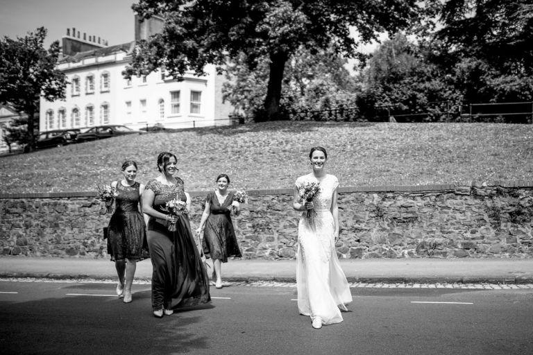 bride and bridesmaids cross the road in clifton to get to goldney house