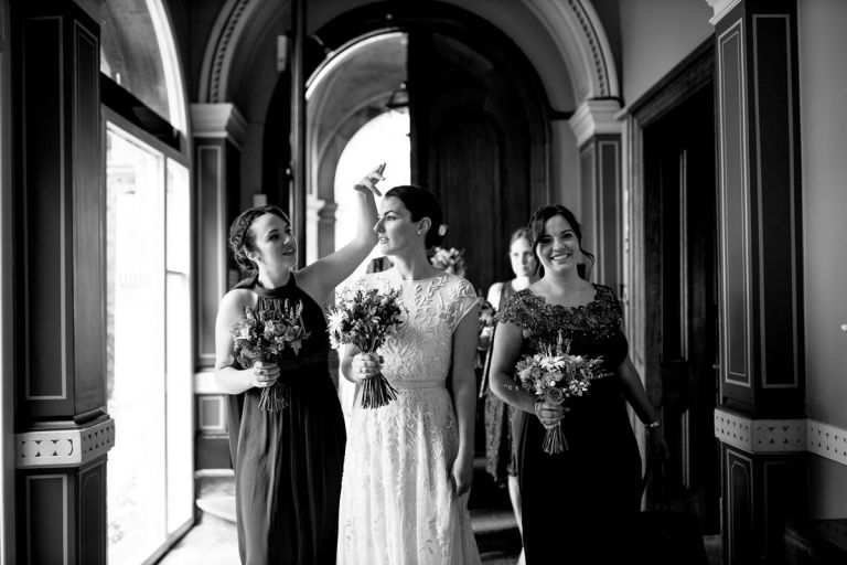 bride and bridesmaids enter goldney hall and prepare themselves for the ceremony
