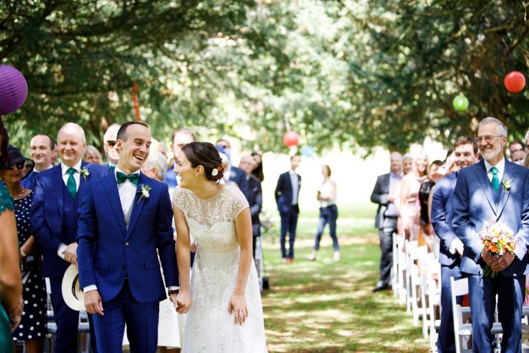 bride and groom laugh at the start of their humanist ceremony at goldney hall