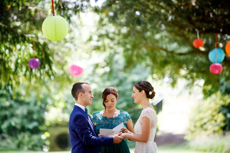 couple saying vows during outside wedding ceremony at goldney hall