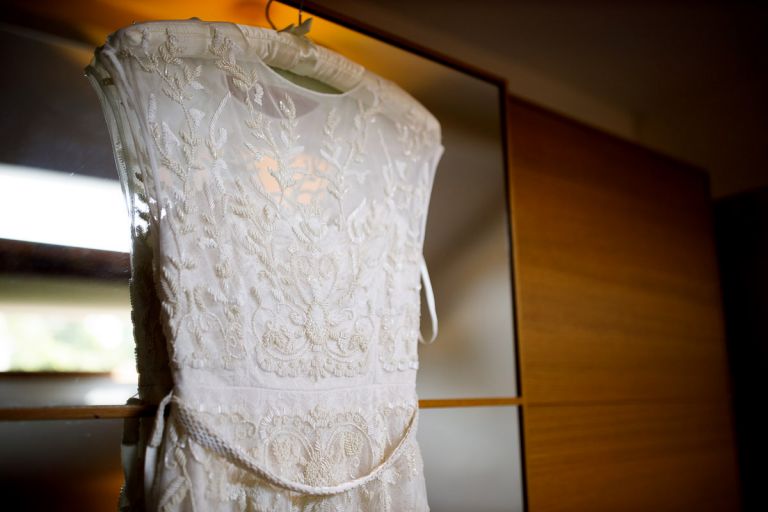 Phase eight wedding dress hung up on wedding morning