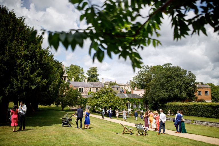 The garden is full of wedding guests outside at goldney hall