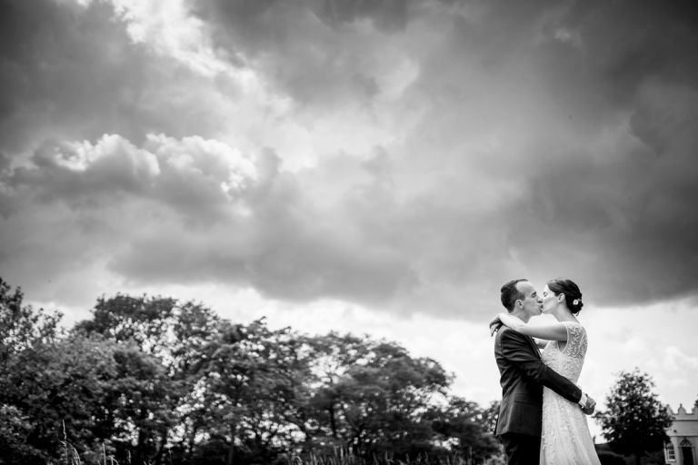 black and white photo of couple kissing at their outside wedding in bristol