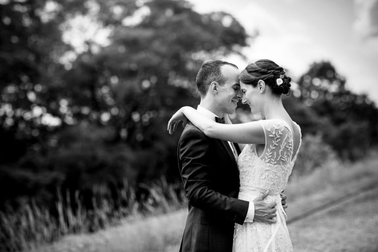 Black and white photo of couple having an intimate moment outside at their wedding at goldney hall