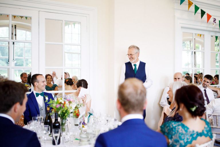 Father of the bride speech at goldney hall, bride hides her face in embarrassment 
