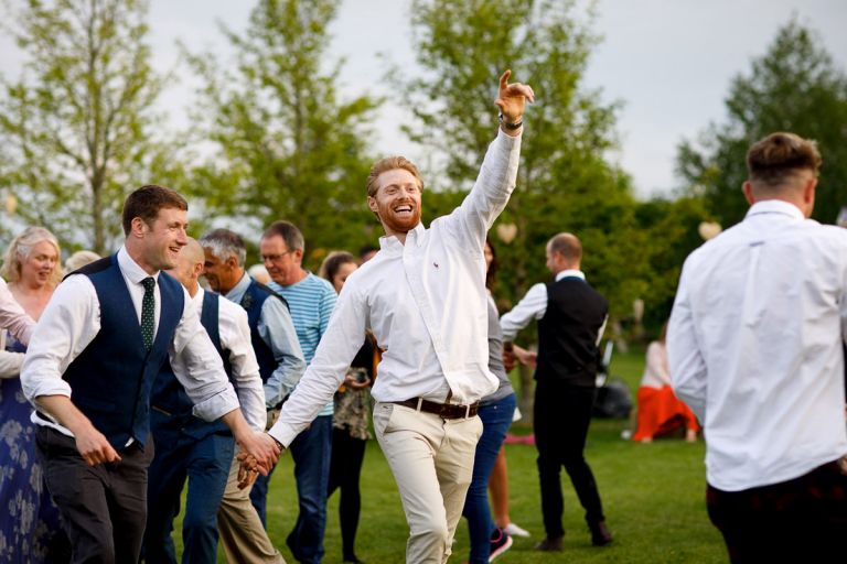 Guest points in the air during outside dancing