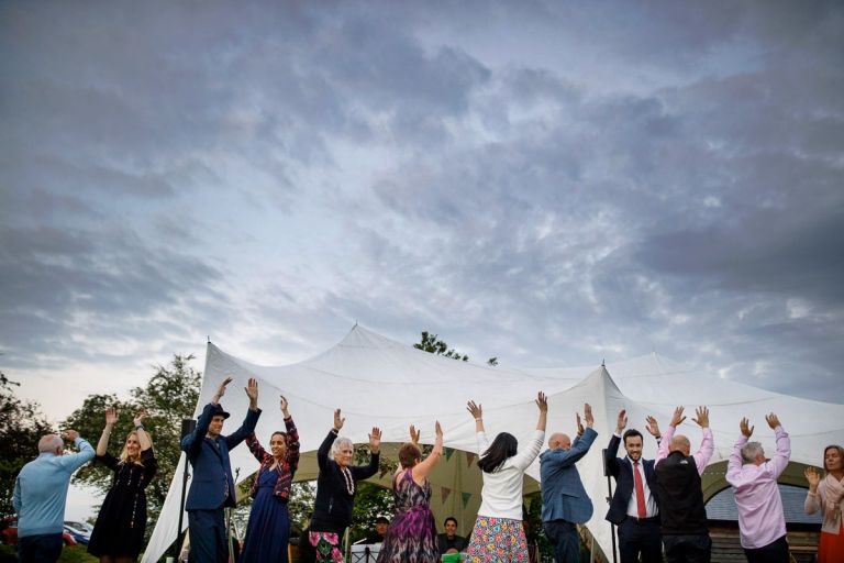 Guest all stick their arms in the air as part of a ceilidh dance