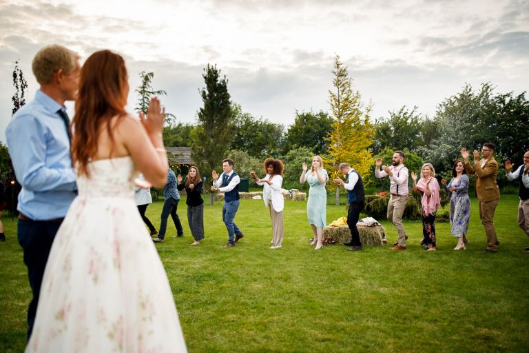 guests clap to couple as part of the wedding dance during a ceilidh