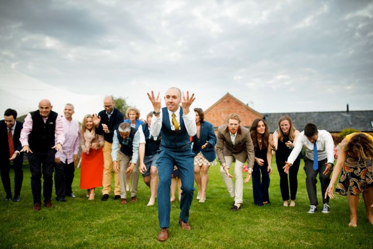 Guest stands infront of other guests during dance to show enthusiasm 