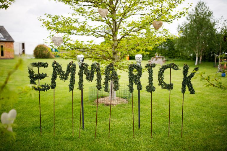 Letters spelling out the names Emma and Rick made of green plants