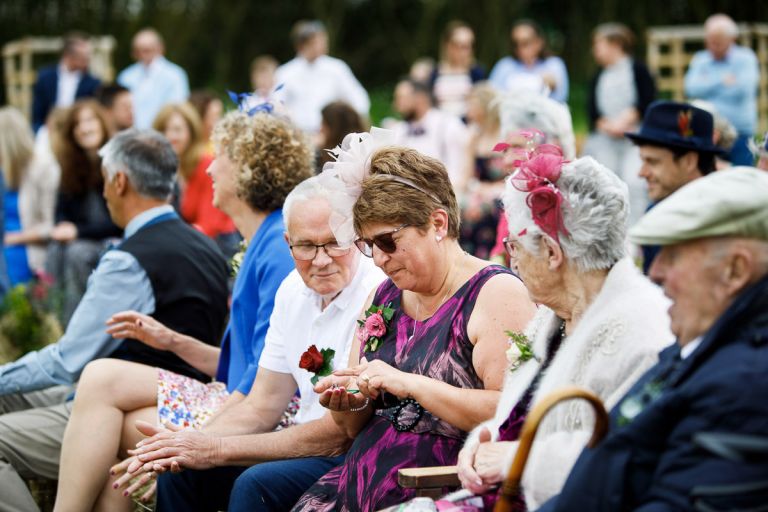 Female guest places a kiss on the wedding rings to send a wish to the couple as part of a ring warming ceremony. 