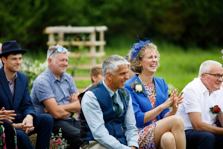 brides parents laugh during the wedding ceremony