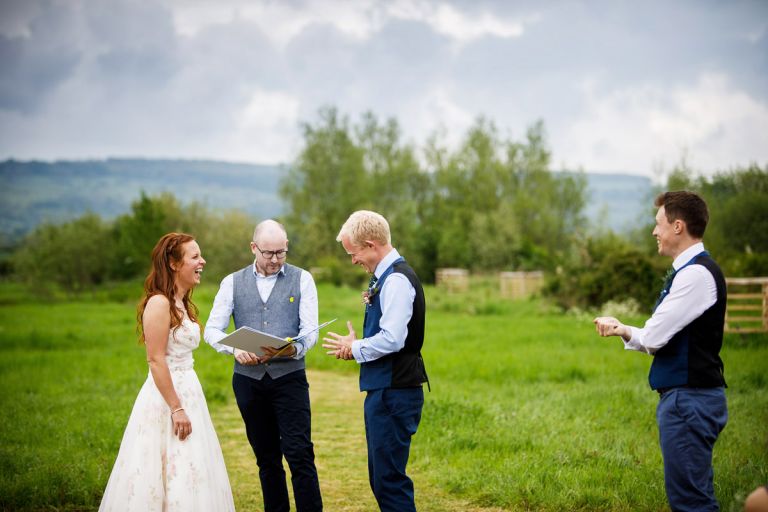Bride and groom laugh at a joke made by the celebrant, MAD ceremonies, while bestman stands to the side with rings laughing. 