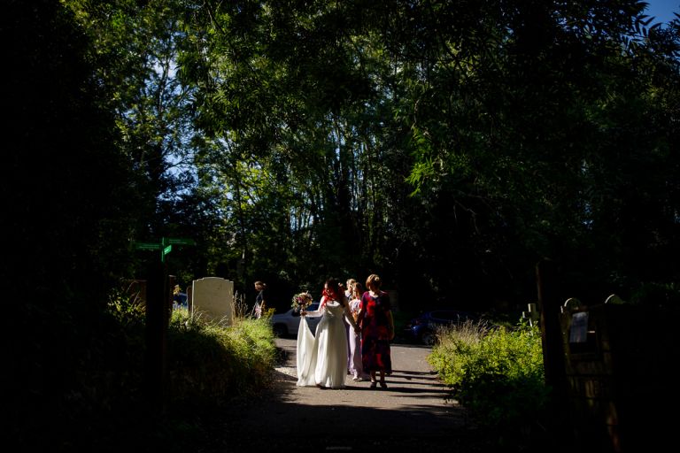 Bride arrives to forest wedding in sunlight